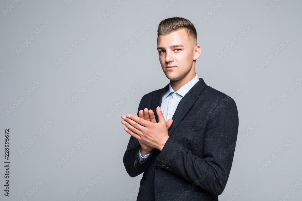Happy young businessman standing and applauding on white background Happy young businessman standing and applauding on white background