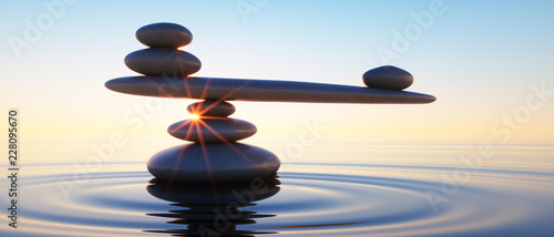 Fotografia Steine in Balance - Gleichgewicht bei Sonnenaufgang im Meer