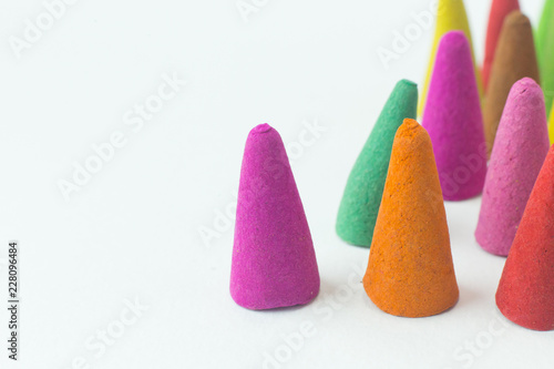 Incense Cone in a stand with the feather for background.