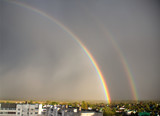 double rainbow over the city, residential area, double rainbow over the blue sky, rainbow