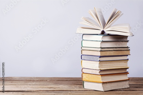 Stacked books on desk at library