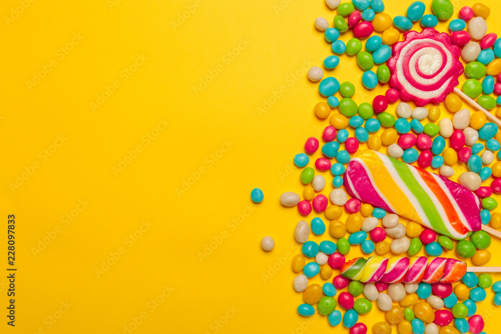 colored candies on yellow background