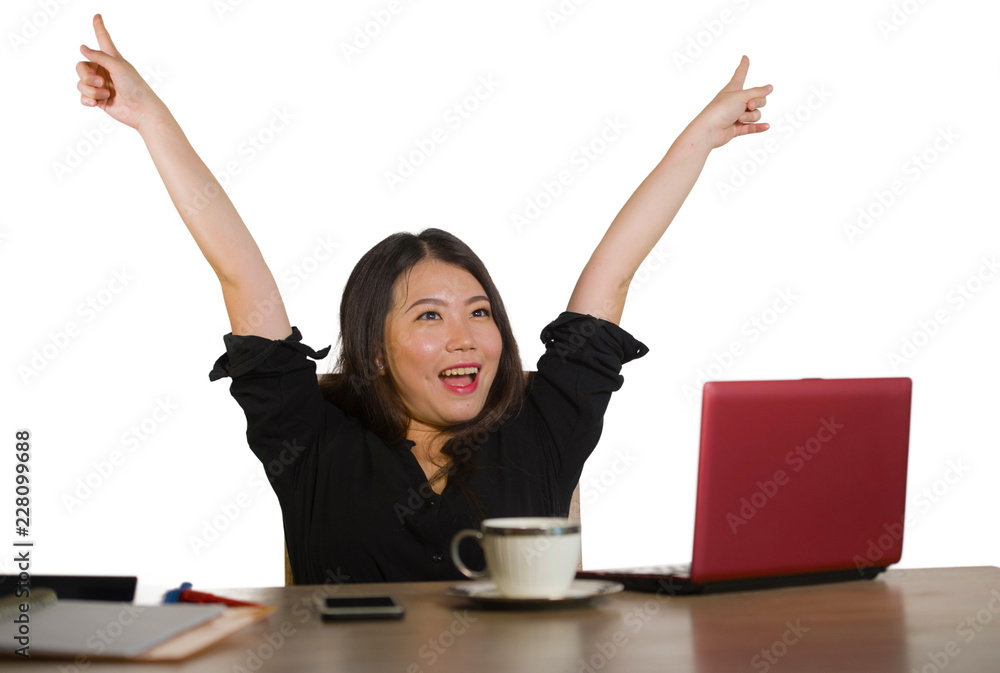 young happy and beautiful Asian Japanese business woman celebrating successful job achievement excited raising arms as a winner working at office computer desk young happy and beautiful Asian Japanese business woman celebrating successful job achievement excited raising arms as a winner working at office computer desk