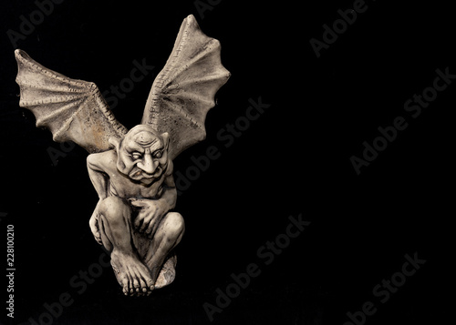 gargoyle with wings on black background