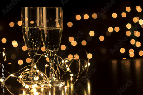 New Year toast champagne led lights,  bokeh lights background photo