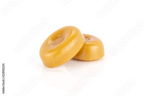 Group of two whole hard caramel cream candy butterscotch variety isolated on white background