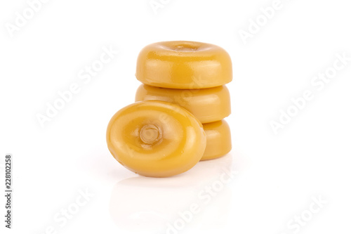 Group of four whole caramel cream candy butterscotch variety isolated on white background photo