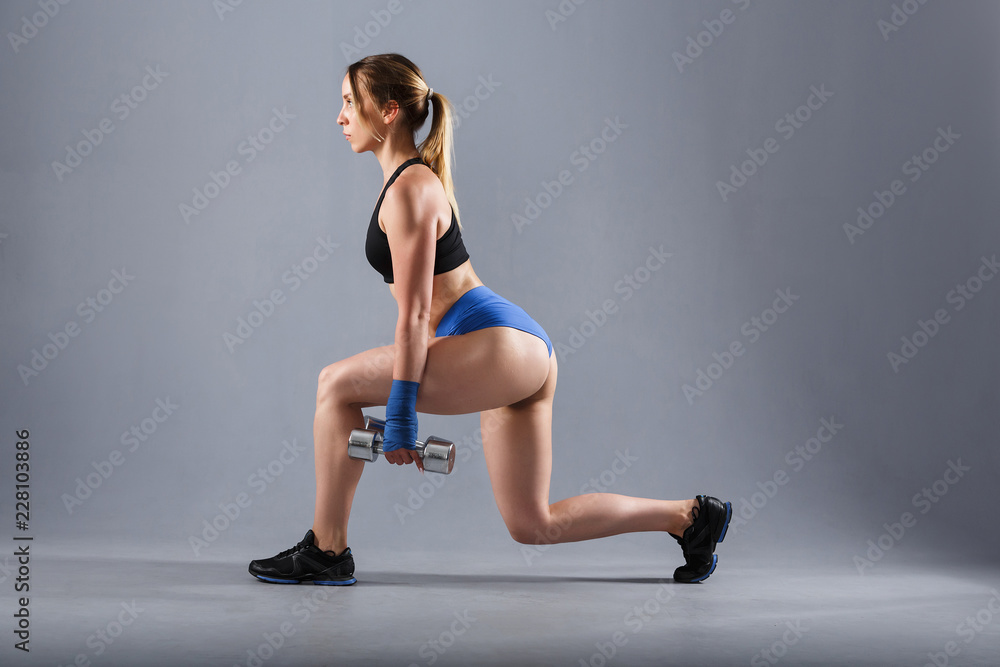 Beautiful young athlete in a sport suit