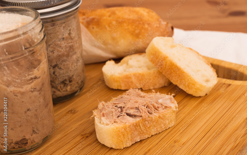 Homemade Rillettes French meat spread made of pork on baguette bread closeup