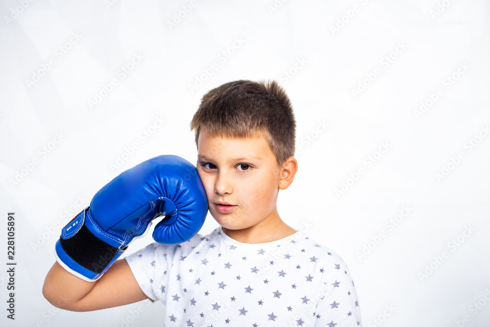 Young champion boy with boxing gloves. Portrait of a sporty boy engaged in boxing. Young champion boy with boxing gloves. Portrait of a sporty boy engaged in boxing.