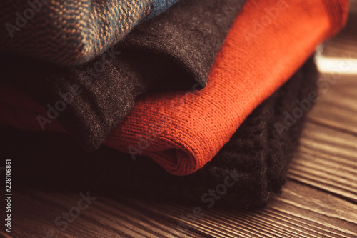 folded woolen things on wooden background insulate  vintage image selective focus