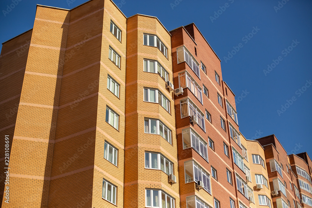 Residential multi-storey building against the blue sky