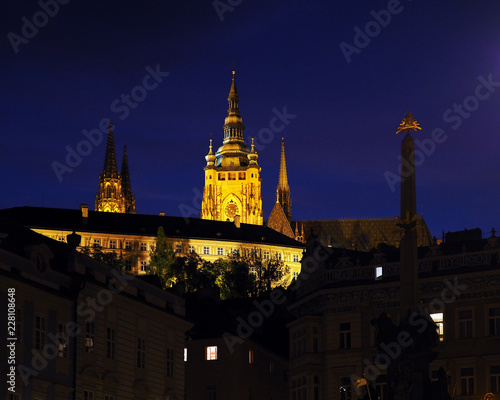 Night Prague, Czech Republic. Prague Castle, Holy Trinity Column, God’s eye placed on top. Lesser Town, square