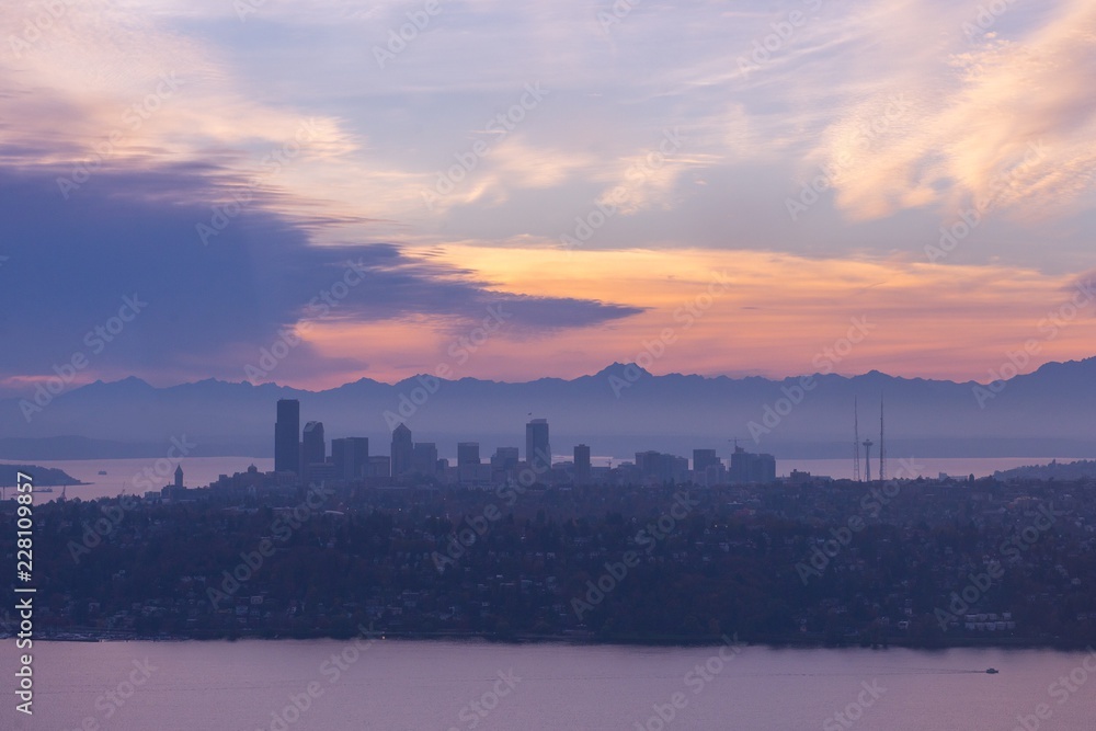 Seattle silhouette at sunset with Olympic mountains in the background - aerial