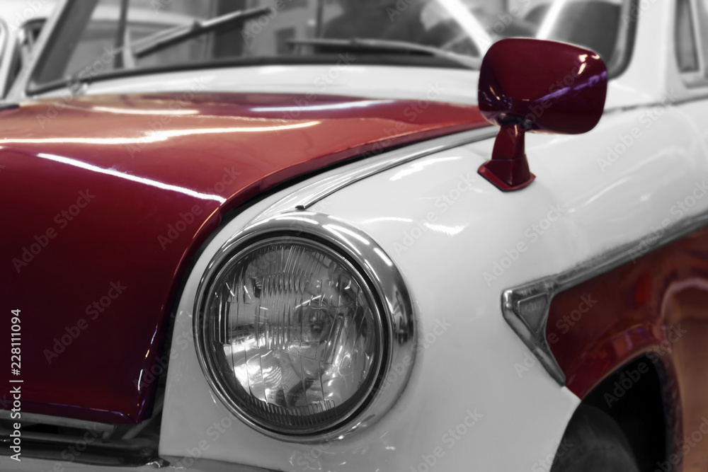 Detail of the front of a white-red vintage car