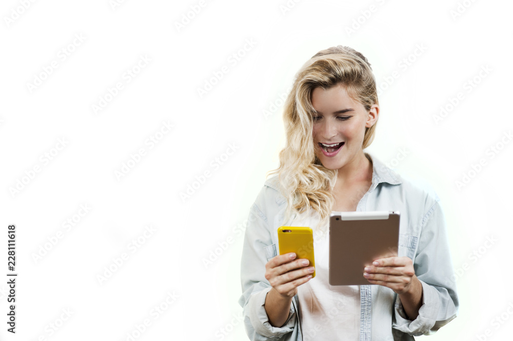 Young very beautiful business girl with a phone and ipad in her hands smiles and laughs at what she saw in on a white background Young very beautiful business girl with a phone and ipad in her hands smiles and laughs at what she saw in on a white background