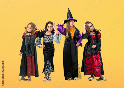 Set of Little girl dressed as a vampire for halloween holidays standing and thinking an idea on orange background