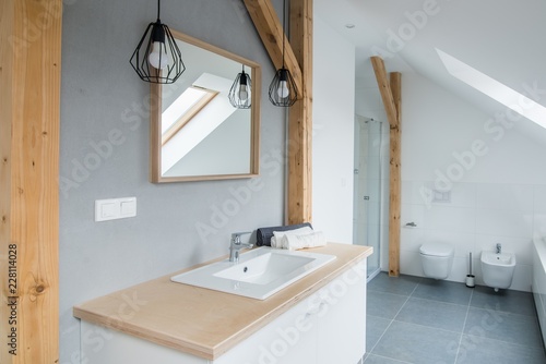 Obraz na płótnie Bright modern bathroom with grey walls, mirror and bathtub. w salonie