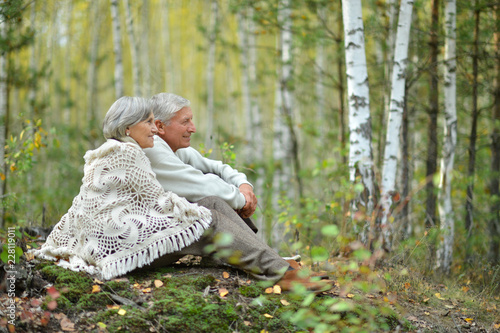 Portrait of old couple at park on autumn background