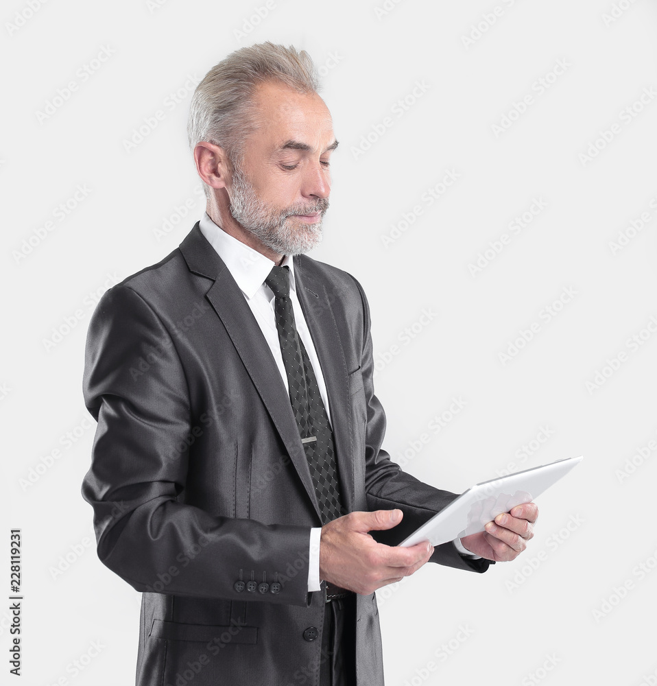 modern businessman reading text on a digital tablet.isolated on grey background