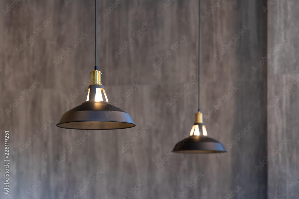 Obraz premium black metal hanging lamp on concrete wall.