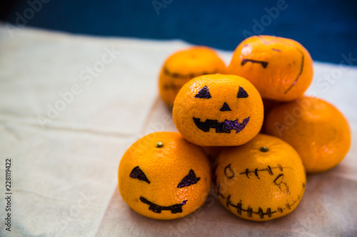Halloween oranges painted as spooky evil on whrinkle cloth