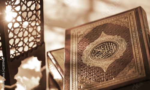 Photo Islamic Book Koran with rosary on grey