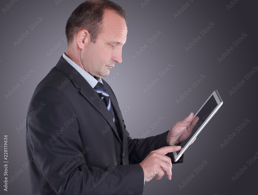 modern businessman with a digital tablet.isolated on black background modern businessman with a digital tablet.isolated on black background