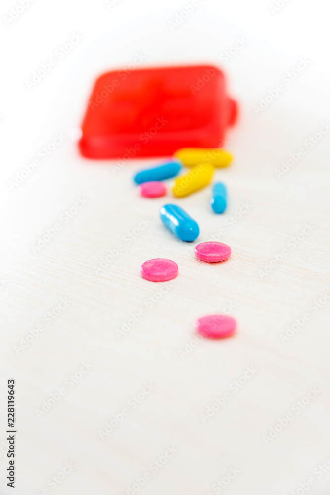 Medicine box and bottle on colorful pills Medicine box and bottle on colorful pills