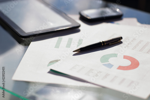 Financial paper charts and graphs on the table