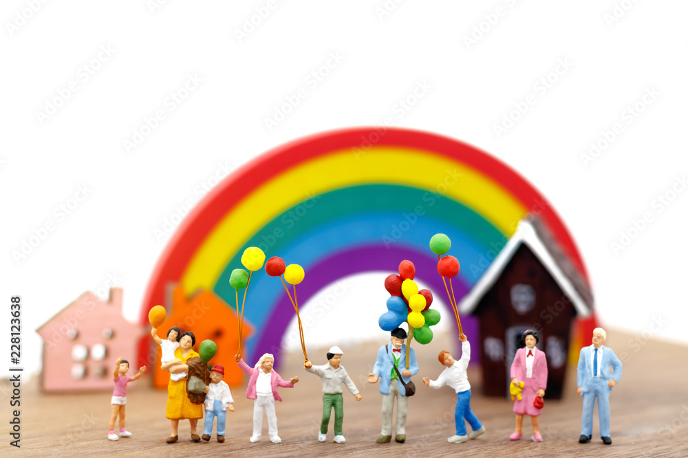 Obraz premium Miniature people: family and children enjoy with colorful balloons, house and rainbow, happy family day concept.
