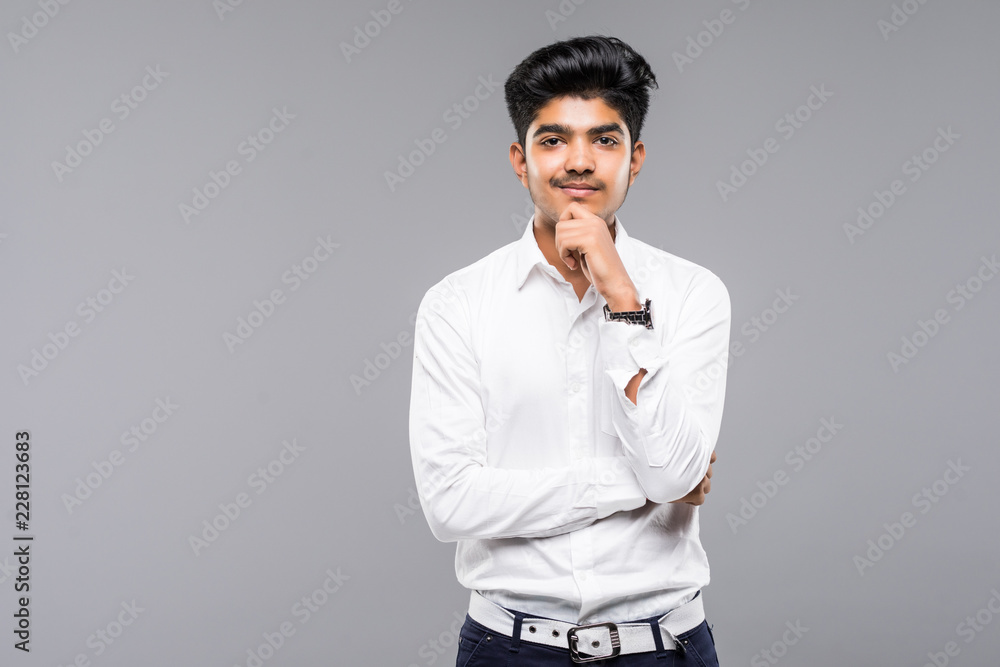 Closeup portrait of handsome man thinking deeply with hand on chin looking upwards isolated on gray background Closeup portrait of handsome man thinking deeply with hand on chin looking upwards isolated on gray background