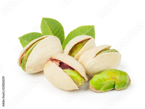 Pistachios with leaves isolated on white background