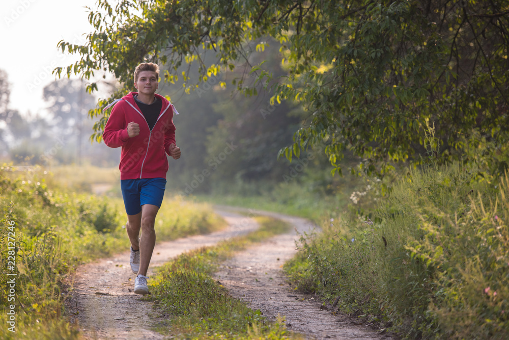 man jogging along a country road
