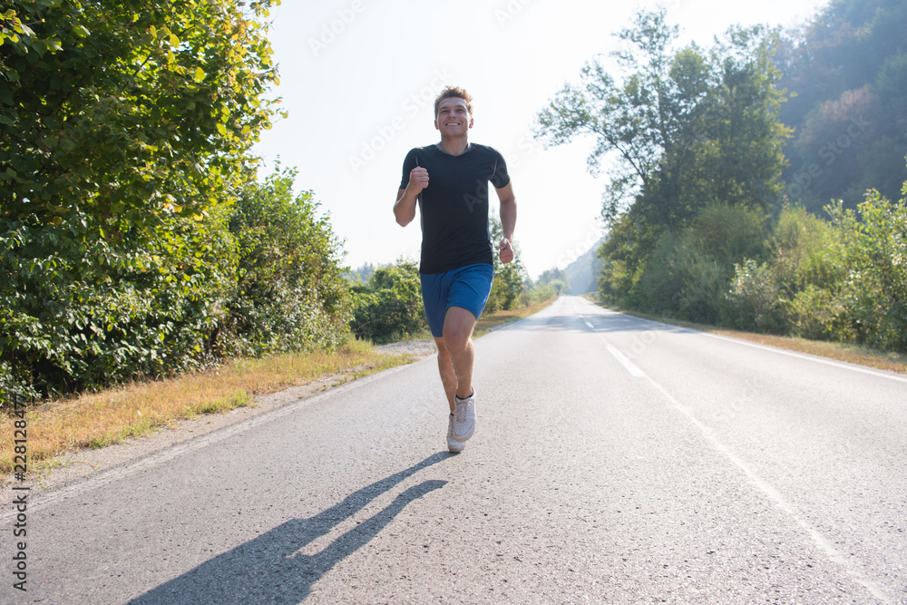 man jogging along a country road man jogging along a country road