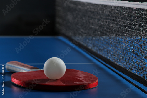 Ping pong. Accessories for table tennis racket and ball on a blue tennis table. Sport. Sport game. © MK studio