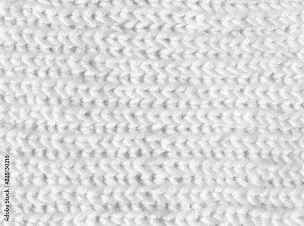 The background is white. The texture of the knitted fabric is made of woolen threads handmade. The background is white. The texture of the knitted fabric is made of woolen threads handmade.