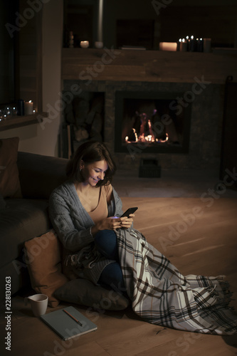 A Woman Enjoying Wintertime and Typing on Cell Phone