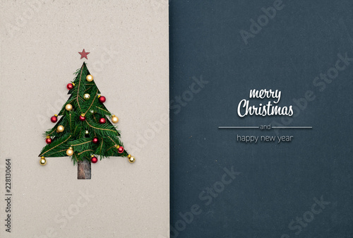 Merry Christmas and happy new year greetings in vertical top view dark blackboard with natural eco decorated christmas tree pine in cardboard.Xmas winter holiday season social media card background 