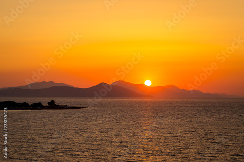 Dramatic sunset over sea surface, Greece Peloponnese. Romantic sunset scenic ocean view in vast Aegean