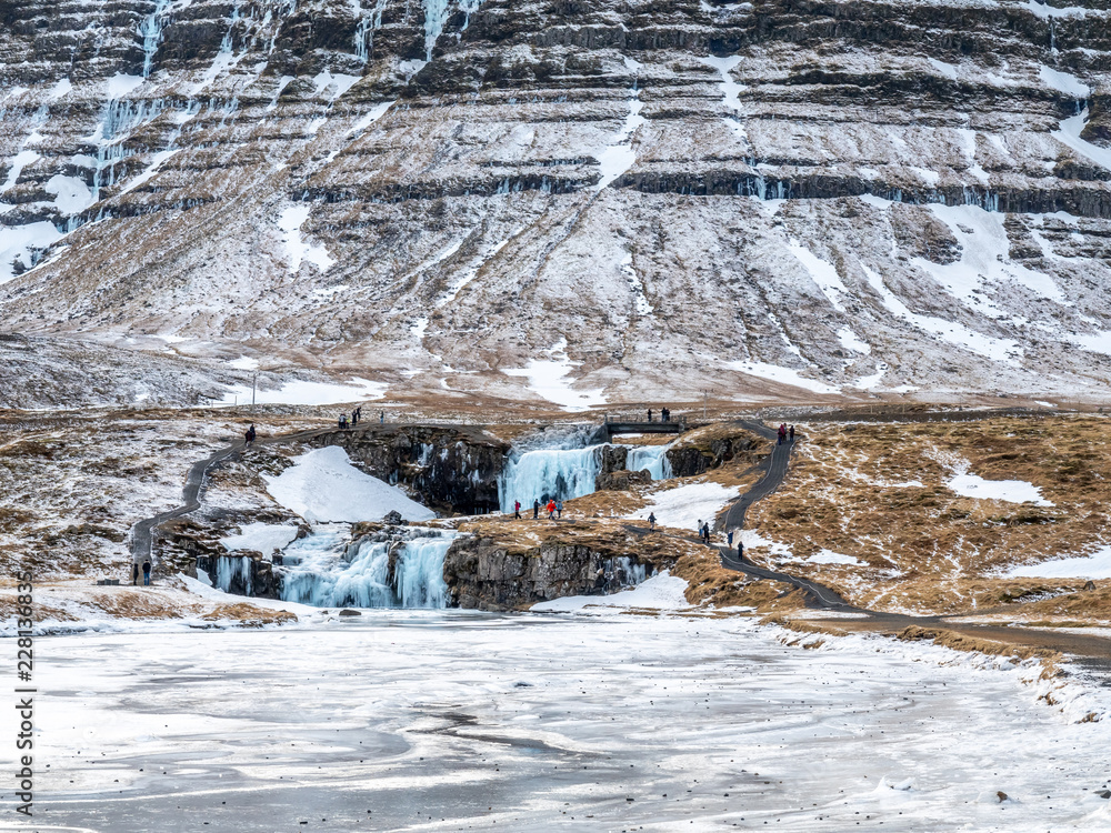 Kirkjufellfoss waterfall in winter, Iceland Kirkjufellfoss waterfall in winter, Iceland