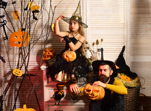 Father and daughter with Halloween decor. Girl and bearded man