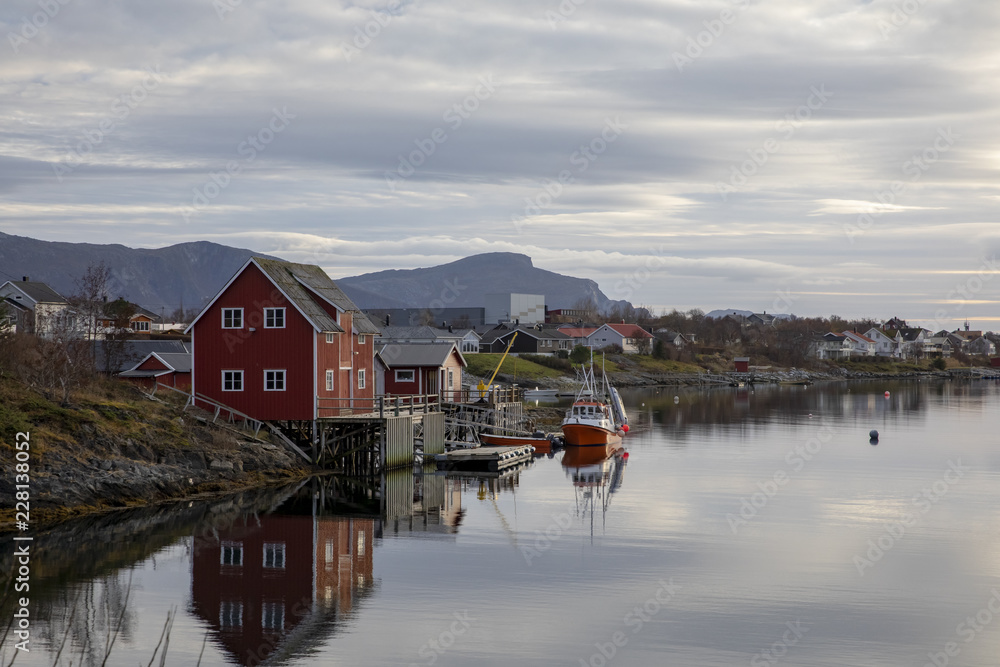Fototapeta premium Red fishing pier and fishing boats in Salhus strait in Brnnoy municipality, Northern Norway 