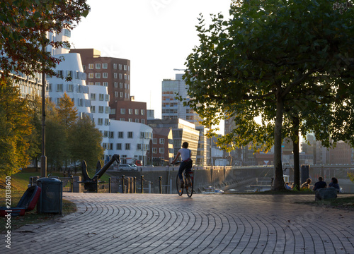 person riding bycicle in warm autumn day in Düsseldorf