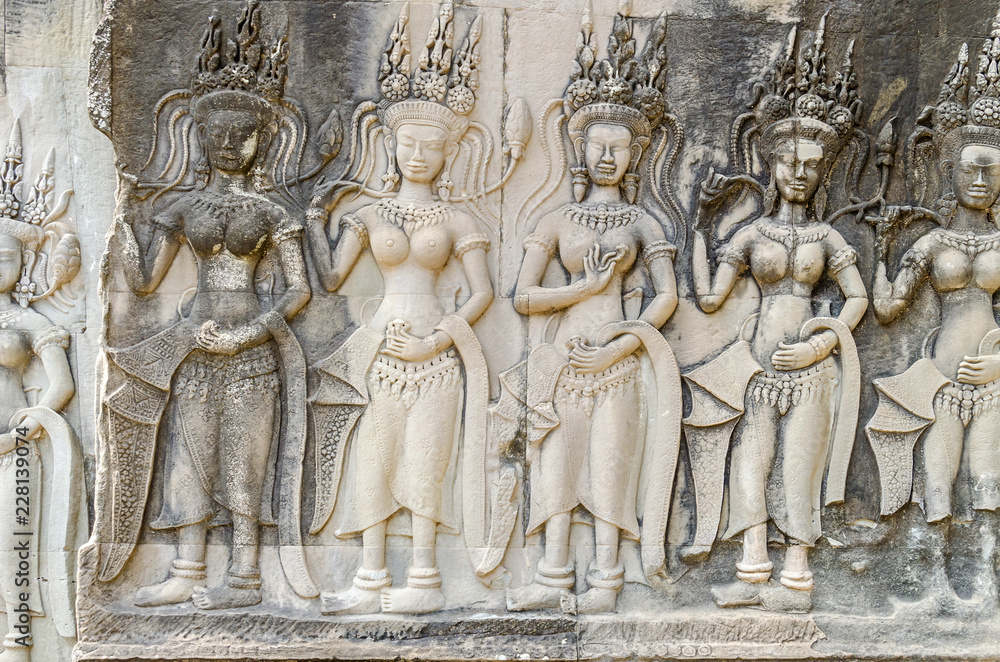 Bas-relief with the devatas adorning the walls of the main complex of Angkor Wat Bas-relief with the devatas adorning the walls of the main complex of Angkor Wat