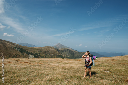 woman goes hiking with a backpack, mountains, nature, travel