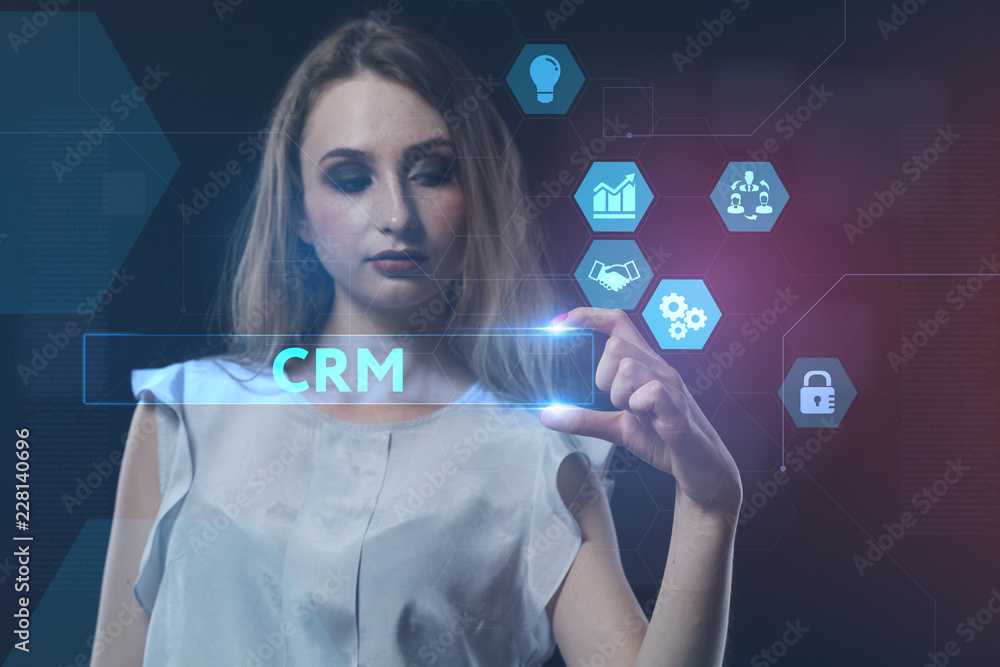 Fototapeta premium The concept of business, technology, the Internet and the network. A young entrepreneur working on a virtual screen of the future and sees the inscription: CRM
