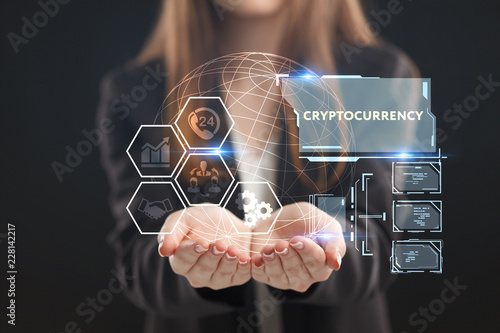 The concept of business, technology, the Internet and the network. A young entrepreneur working on a virtual screen of the future and sees the inscription: Cryptocurrency