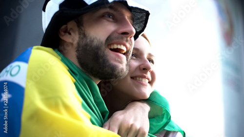Excited Brazil football fans hugging and celebrating victory of national team