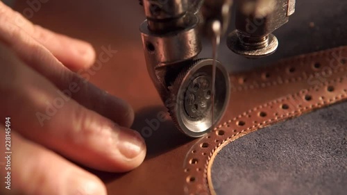 sewing machine and red leather with a seam close-up. sewing process. photo